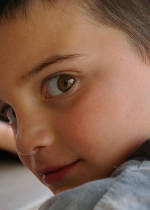 Close photo of a boy glancing backwards