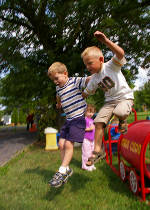 Photo of two boys jumping down together