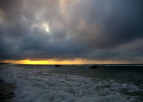 Photo of a cloudy sunrise at the ocean